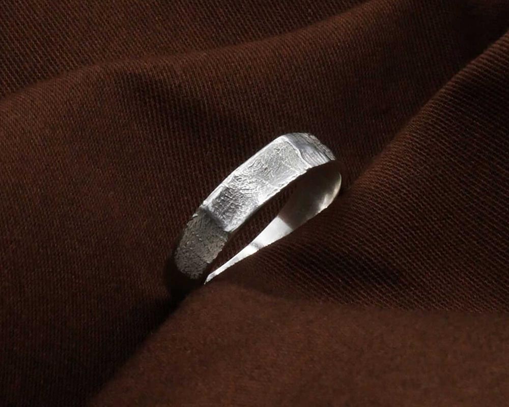 Alliance avec empreintes digitales posée sur tissu 